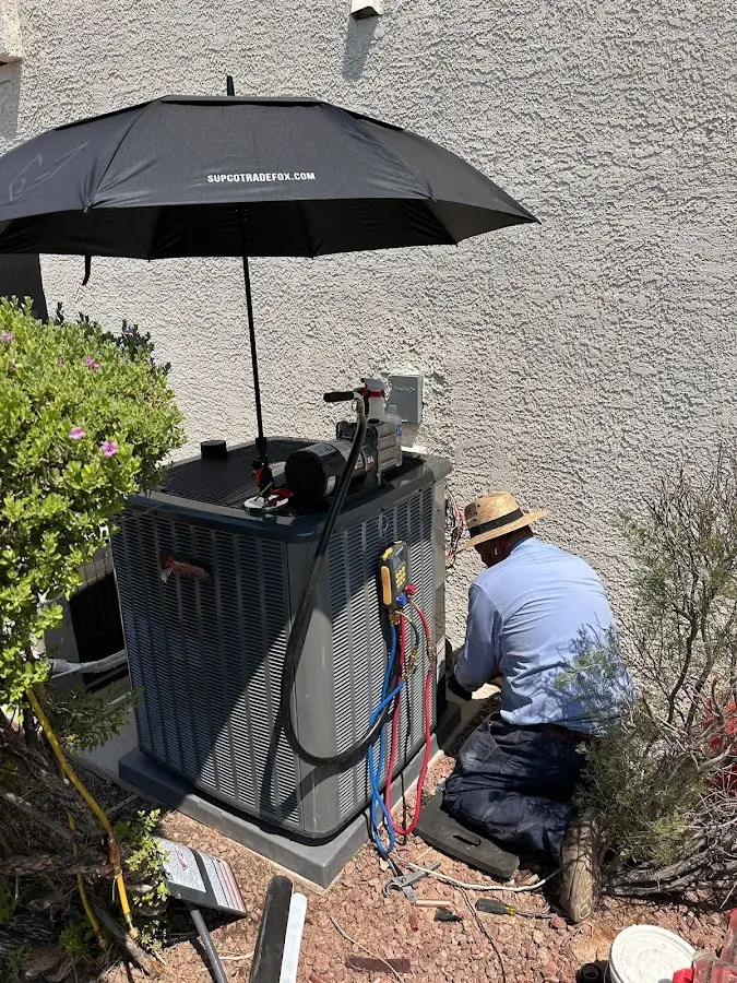 HVAC technician performing outdoor AC maintenance in Walden